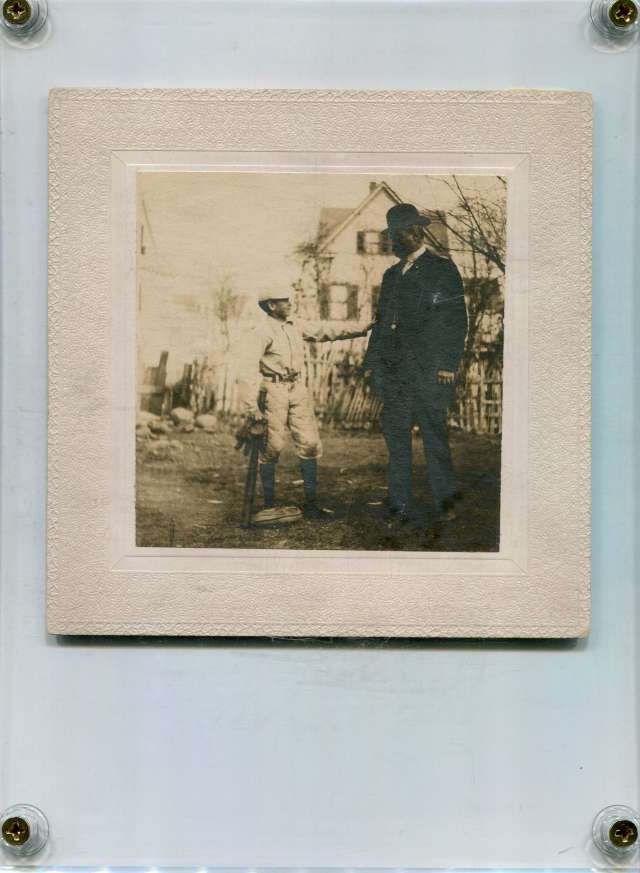 Man With Boy Holding Bat and Glove